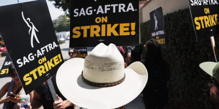 Striking actors and writers ‘trying to make a living’ brace for a long summer on the picket lines in their standoff with studios Striking actors and writers ‘trying to make a living’ brace for a long summer on the picket lines in their standoff with studios