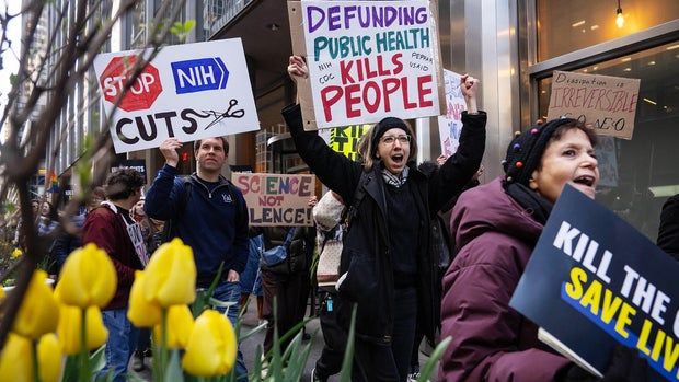 Health expert calls Trump's medical research cuts "reckless destruction" 2 Demonstrators Protest Trump Administration During Kill The Cuts Day Of Action