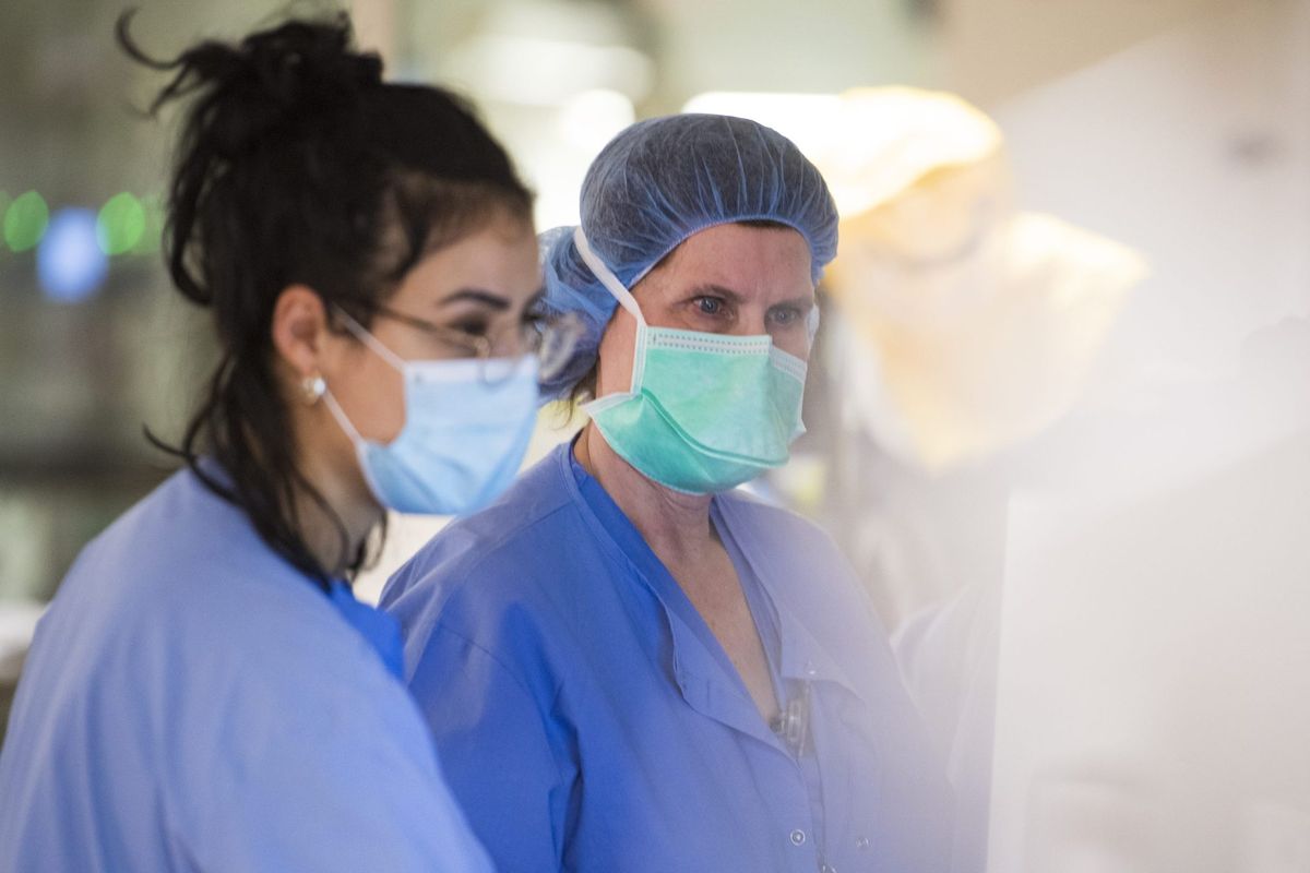 Soaring COVID and flu cases, described as 'moderately severe' in number, are prompting hospitals to restore mask mandates 1 cfad3ea8 GettyImages 1230820240 e1704331214311