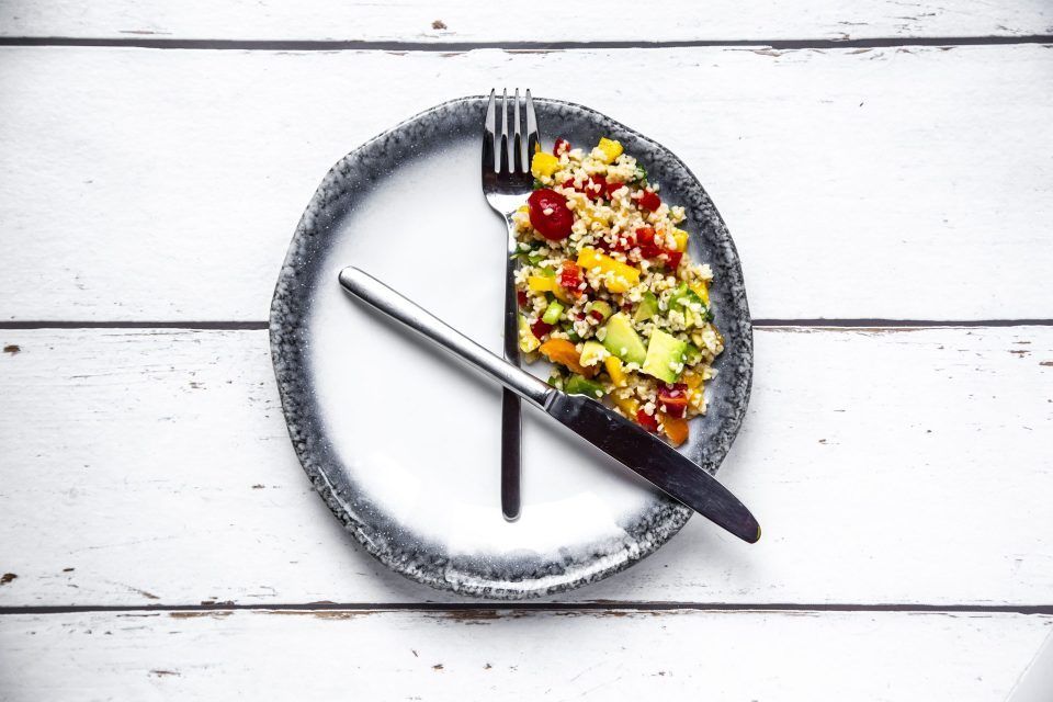Intermittent fasting is winning over the C-suite as experts say it improves sleep, focus, and memory. Here’s how to make it work for you 1 Bulgar salad on round plate, symbol for intermittent fasting.