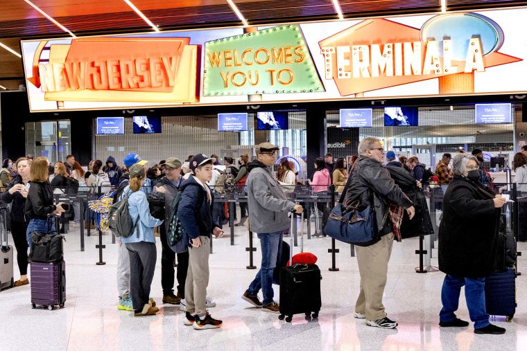 This summer’s travel trends: Shorter, cheaper trips and more driving — unless you’re rich 2 Travelers stand in line to pass through a security checkpoint at Terminal A at Newark Liberty International Airport (EWR) in Newark, N.J. on Jan. 12, 2023.