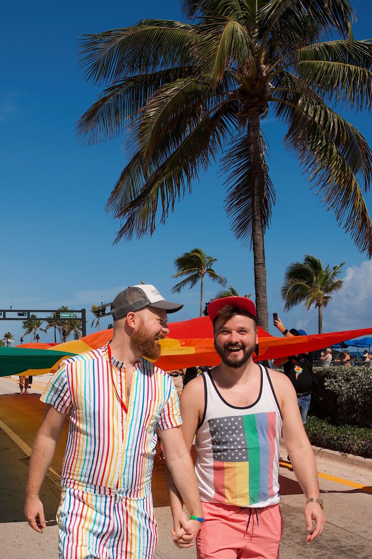 Some global LGBTQ travelers are skipping America this Pride season 1 Daan Colijn and Karl Krause smiling and holding hands during Fort Lauderdale Pride