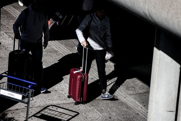 Election anxiety is scrambling Americans’ travel plans 1 Travelers with suitcases.