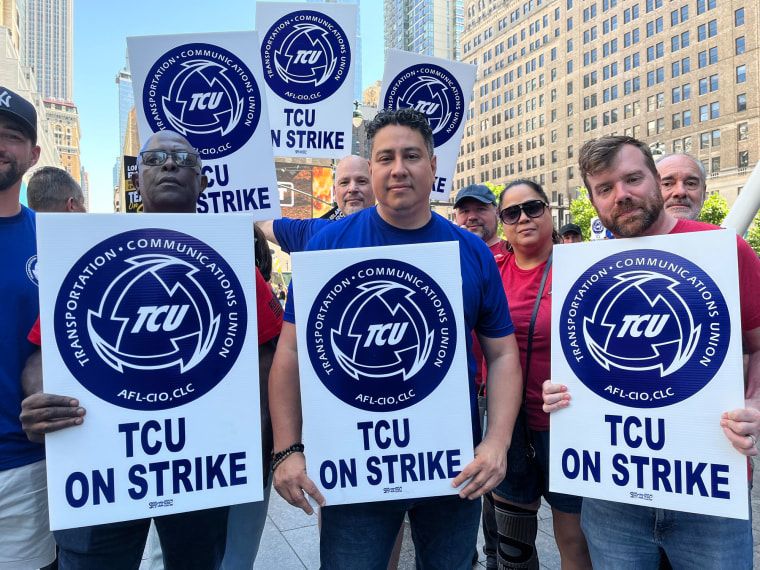 New York braces for chaotic Monday commute amid Long Island Rail Road strike 4 People hold picket signs on the street outside