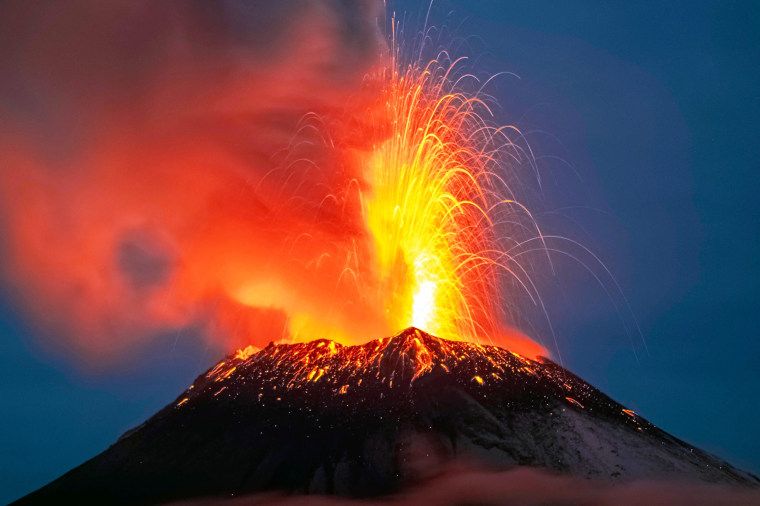 Volcano spews ash over Mexico City and disrupts travel at two major airports 1 Incandescent materials, ash and smoke are spewed from the Popocatepetl volcano as seen from thr Santiago Xalitzintla community, state of Puebla, Mexico, on May 22, 2023. Mexican authorities on May 21 raised the warning level for the Popocatepetl volcano to one step below red alert, as smoke, ash and molten rock spewed into the sky posing risks to aviation and far-flung communities below. Sunday's increased alert level -- to "yellow phase three" -- comes a day after two Mexico City airports temporarily halted operations due to falling ash.