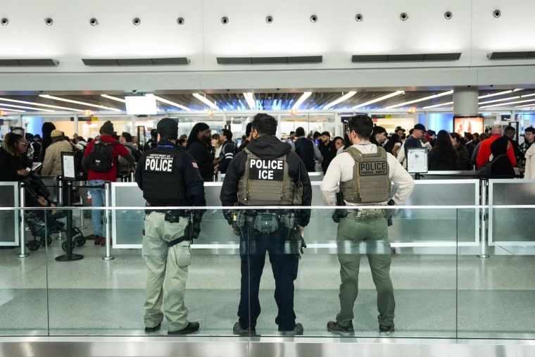 ICE agents sent to airports to assist TSA as partial shutdown drags on 2 Three ICE agents watch a line of people inside of an airport