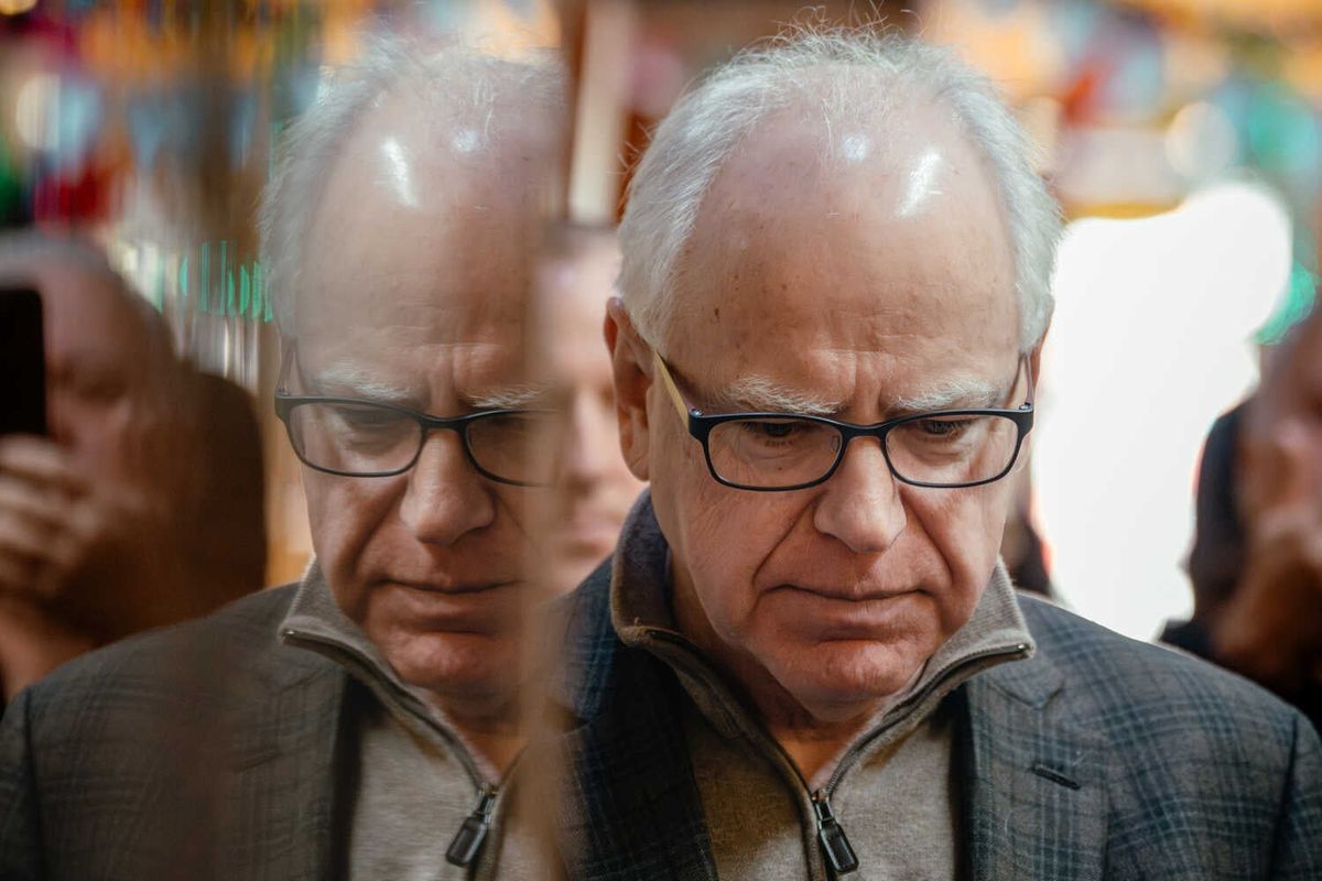 Video: Walz Drops Re-Election Bid as Minnesota Fraud Scandal Grows 1 Gov. Tim Walz, in a zip-up sweater and jacket, looks down as he stands in front of colorful items on walls.